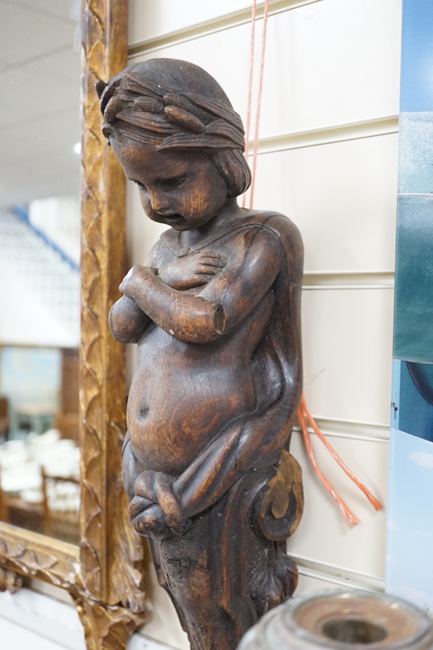 A carved figural wall mount. 64cm tall